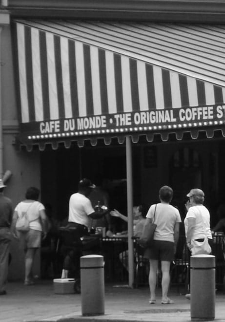 Black and white phote of Cafe du Monde.  Coffee is coffee, right? So, why go to Cafe du Monde versus another cafe? People don't just buy things.  Behavioral Science explores decision making.